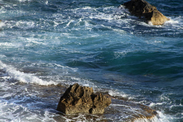 istock Blue sea waves and rock, for backgrounds or textures 2203107360