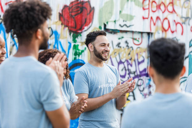 istock Diverse Group of Volunteers Applauding a Speaker at Community Event 2203108591