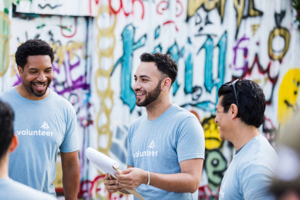 istock Multiracial Group of Volunteers Smiling in Front of Graffiti Wall 2203108595