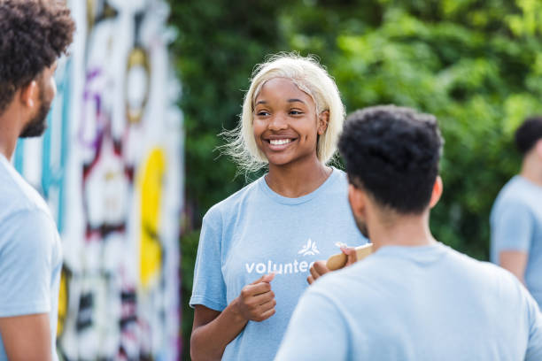 istock Smiling Volunteer Talking with Community Members Outdoors 2203108597