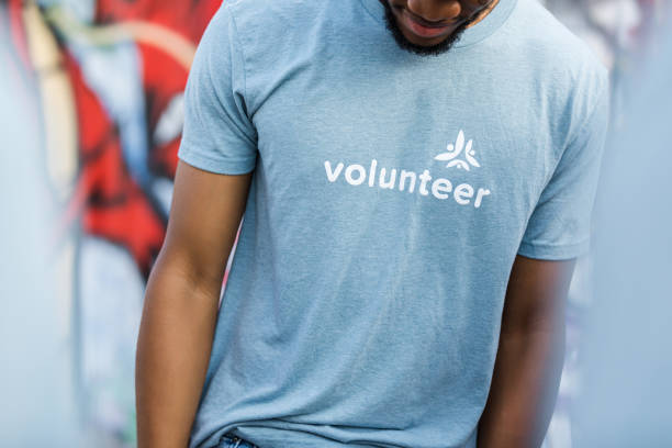 Volunteer wearing a light blue t-shirt with logo
