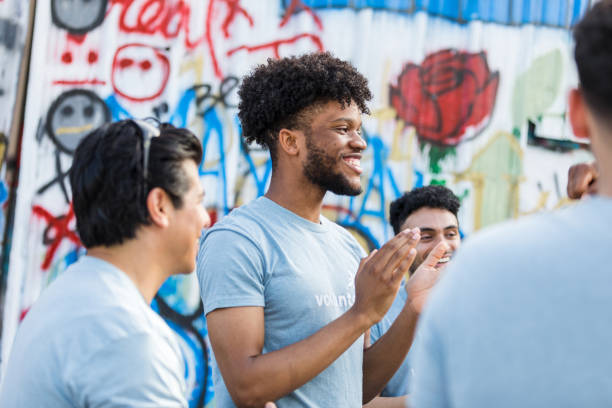 istock Multiracial Group of Volunteers Clapping, Showing Happiness and Teamwork 2203108625