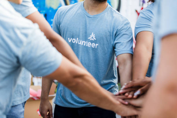 istock Teamwork and Volunteerism: A Group of Diverse Volunteers 2203108633