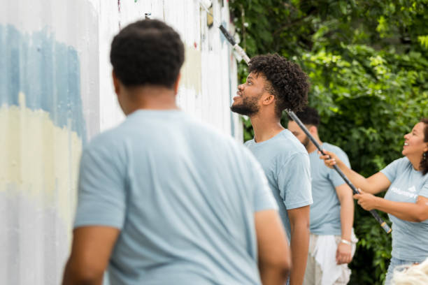 istock Community Teamwork: Painting a Mural, Volunteers Working Together 2203108640