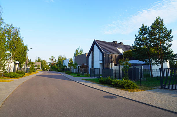 istock Road in gated community with luxury buildings. 2203110776