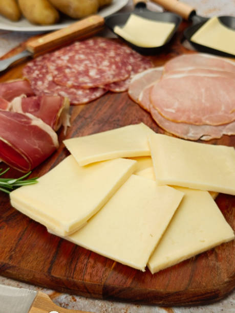 istock raclette cheese and cold cuts, close-up 2203112898