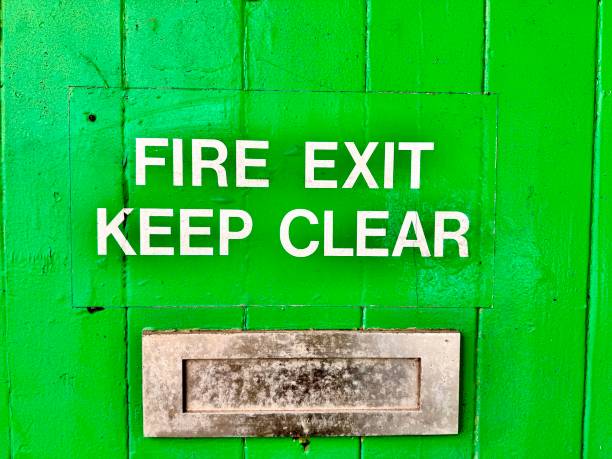 istock A green wooden door with FIRE EXIT KEEP CLEAR text and a letterbox 2203118305