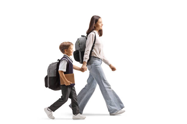 istock Older sister taking her brother to school 2203118717