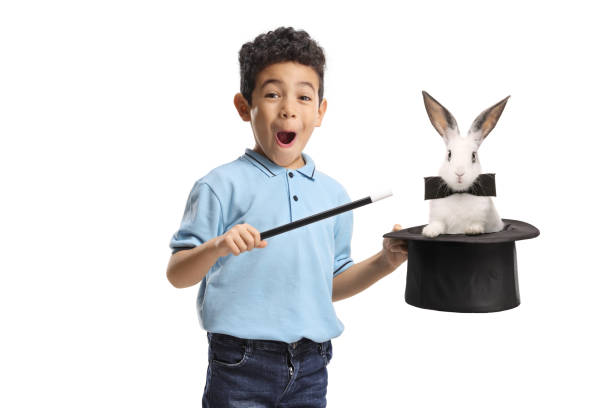 istock Boy holding a magician top hat with a rabbit 2203118770