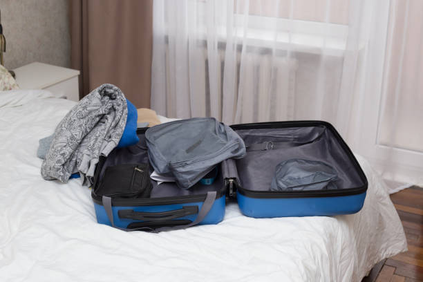 istock Man Packing Suitcase in Hotel Room 2203119229