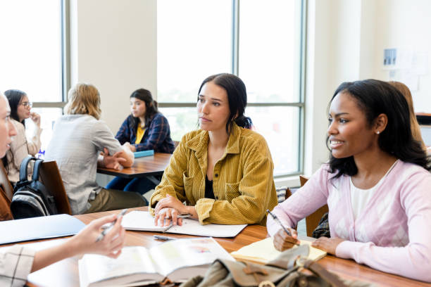 istock Diverse group of students studying together in a university classroom 2203120203