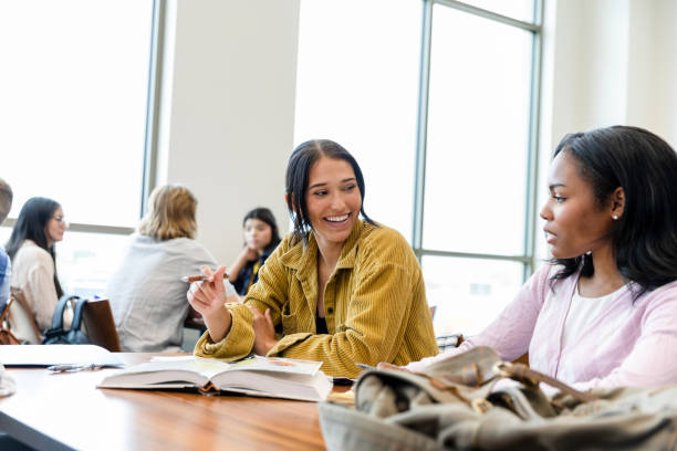istock Two Diverse Female Students Studying Together in a Modern Classroom 2203120207