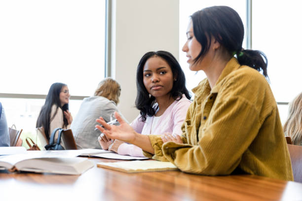 istock Two Diverse Female Students Discussing in a Classroom 2203120209