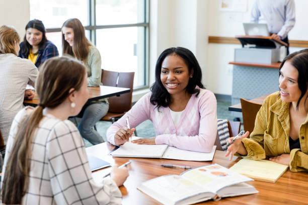 istock Group of female university students studying together in a classroom 2203120216