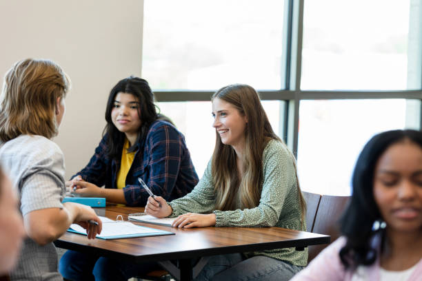 istock Happy Diverse Group of Students Studying Together in Classroom 2203120245