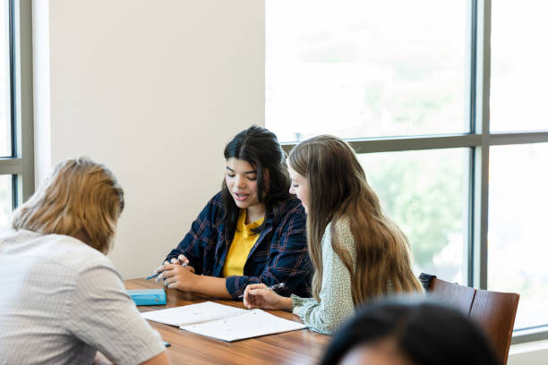 istock Two Young Women Studying Together in a Library 2203120254
