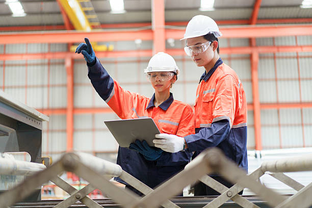 istock Team of engineers are perform the inspection on a machines. 2203120431
