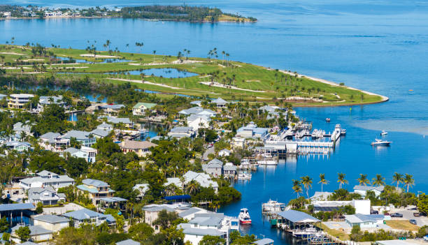 istock Premium housing development in the USA. Expensive waterfront houses between green palm trees in Boca Grande, small town on Gasparilla Island in southwest Florida 2203125145