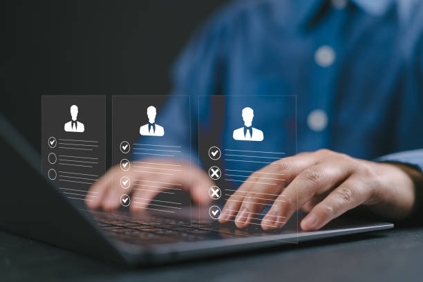 istock businessman using laptop with Personal information file storage concept ,HR checklists of employees Corporate data management system and document management system with employee privacy. 2203131040
