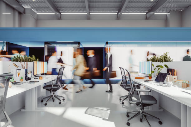 Busy office environment with people in motion. 3D generated image. People in motion/camera facing are generic human figures not based on any real person. All monitor/laptop images are my own and are just 3D renders as well.