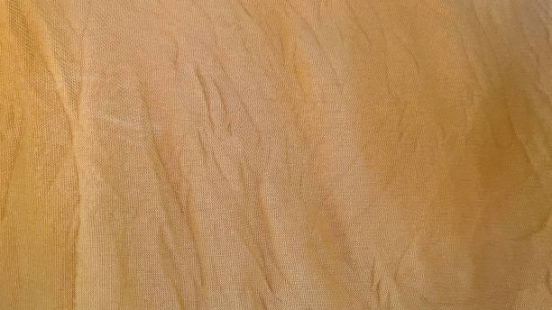 istock Close up of wrinkled yellow fabric texture 2203134187