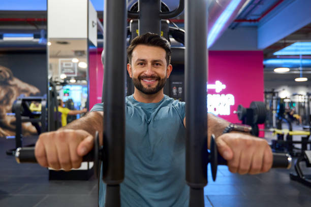 istock Man exercising on chest press machine in gym 2203134616