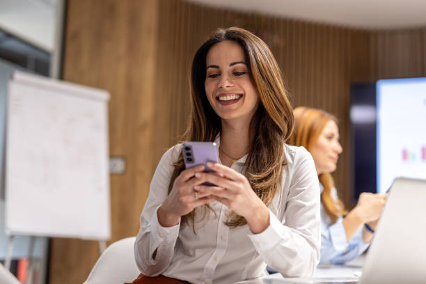 istock Smiling businesswoman using smartphone during office meeting 2203138065