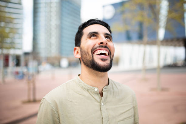 istock Carefree young arabic man laughing outside 2203139515