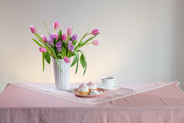 istock cup of tea and cupcakes with spring flowers in light colors 2203140178