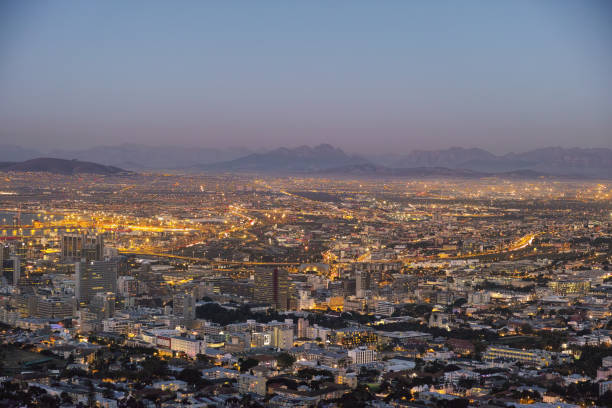 istock City view at dusk with illuminated urban skyline surrounded by distant mountains 2203140190