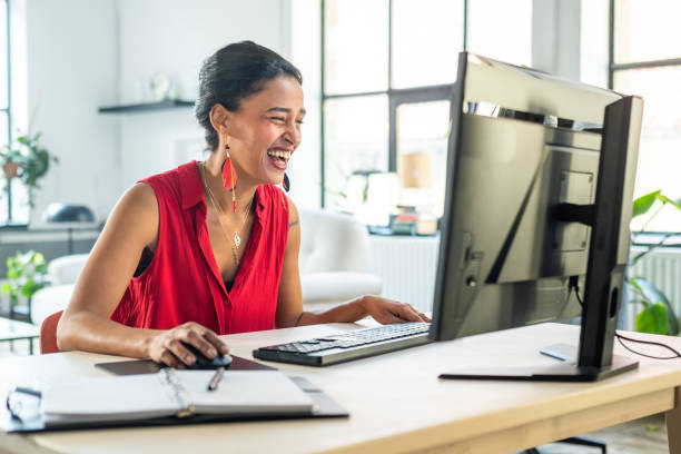 istock Cheerful Mixed Race Woman Working on Desktop PC in Home Office 2203140256