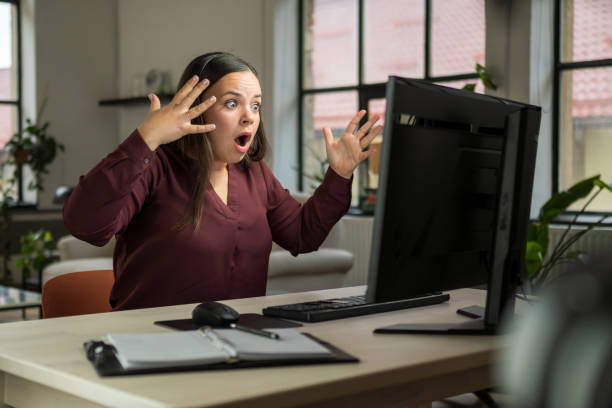 istock Frustrated Woman Reacting to Computer Screen in Home Office Setting 2203140273