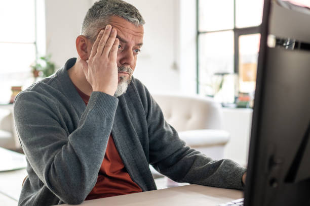 istock Concerned Mature Caucasian Man Using Desktop at Home 2203140347