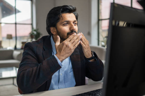 istock South Asian Professional Man Looking Surprised at Laptop Screen 2203140412