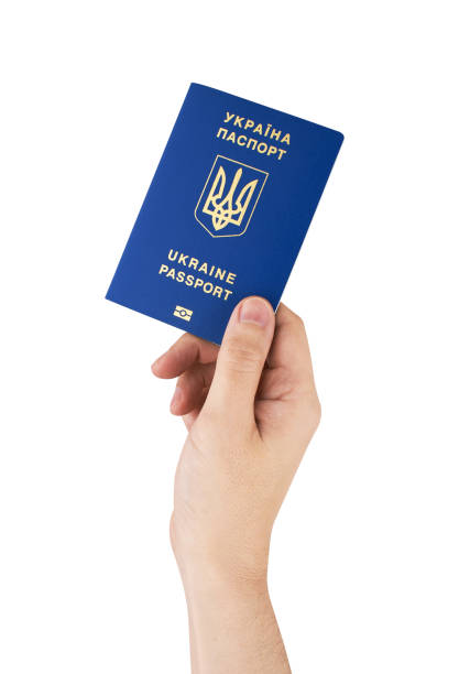 istock Passport of Ukraine in hand isolated on white 2203141028