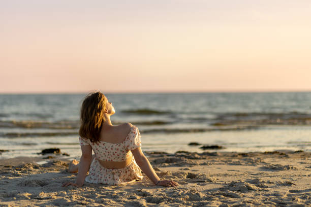 istock Relaxation at sunset on a tranquil beach with gentle waves and soft sand 2203142171