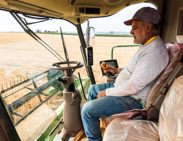 istock Farmer Operating Combine Harvester in Wheat Field 2203142467