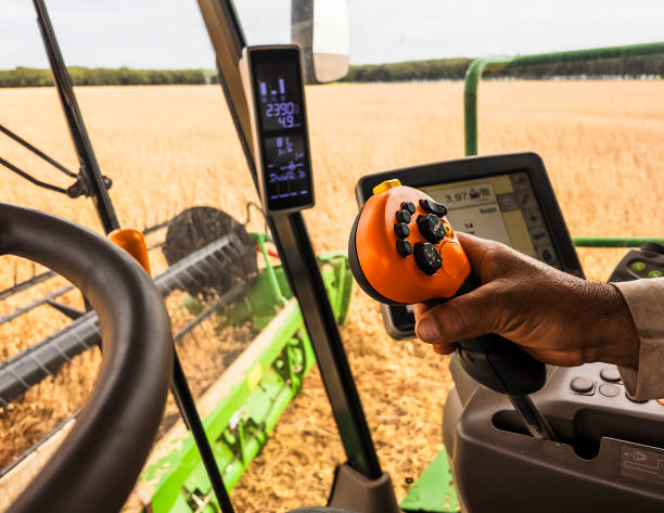 istock Farmer Operating Combine Harvester in Wheat Field 2203142502