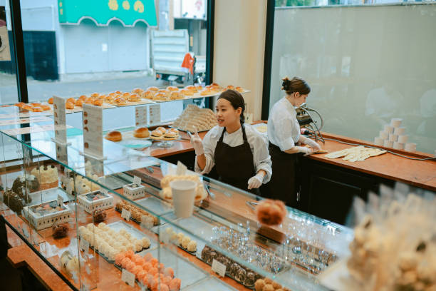 istock Young women preparing croissants in a bakery in Tokyo 2203142504