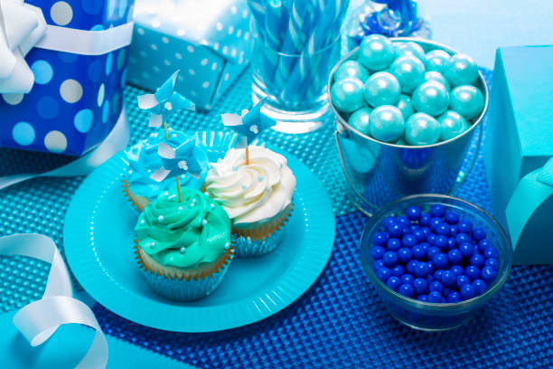 One Year Old Boy Birthday Cupcakes with candy and present decorations on a blue background