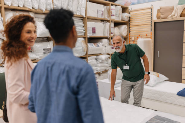 istock Sales associate demonstrating mattress comfort level 2203145781