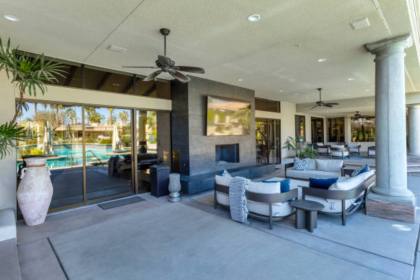 istock Outdoor lounge area with fireplace and TV 2203148419