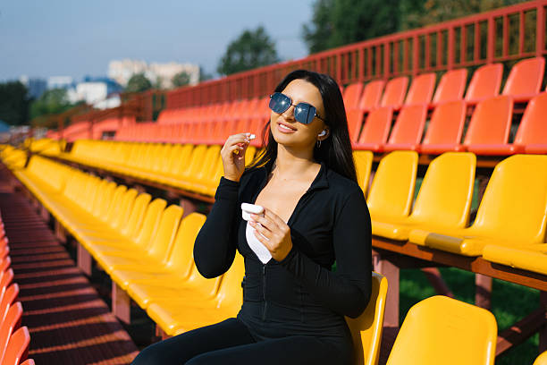istock Smiling Woman With Earbuds 2203148496