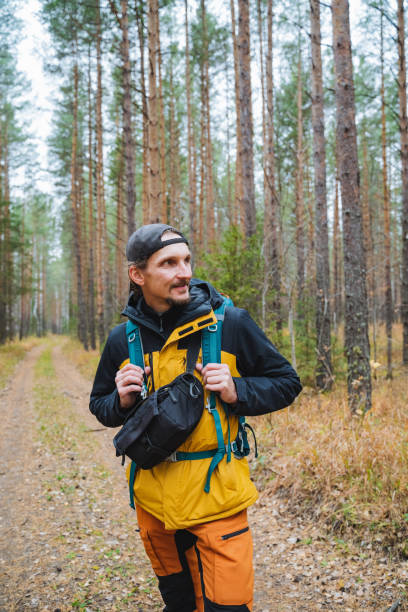 istock An eager adventurer enthusiastically explores the scenic and serene forest trails while carrying a trusty backpack, enjoying natures beauty 2203149550