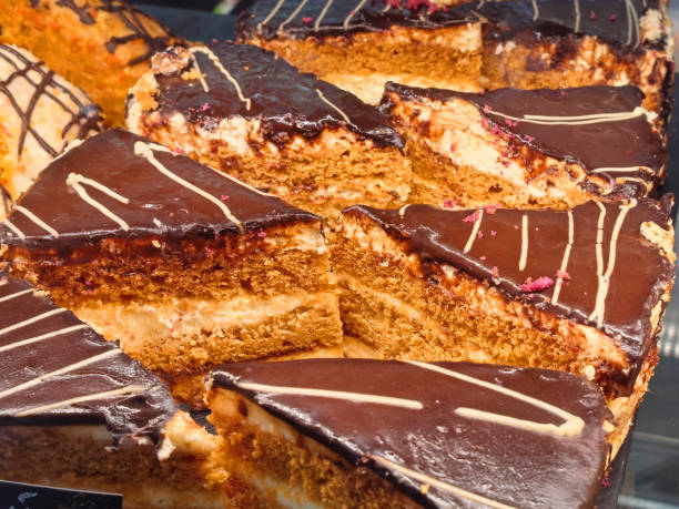 Cakes with rich chocolate frosting displayed in a bakery shop window