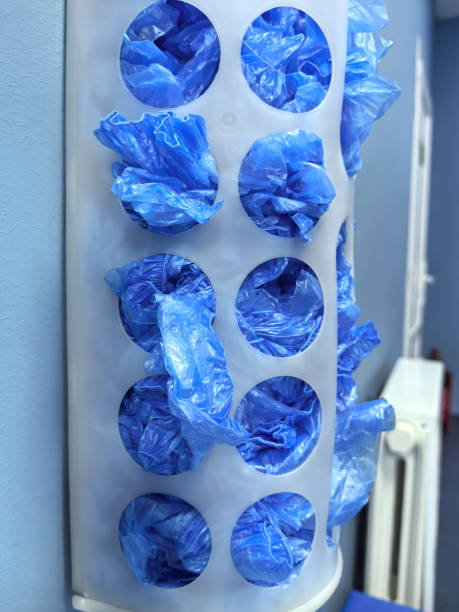 istock Disposable shoe covers neatly stored in a wall-mounted dispenser for visitors 2203150309