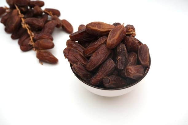 istock Dried dates fruits in ceramic bowl isolated on white background. 2203152483