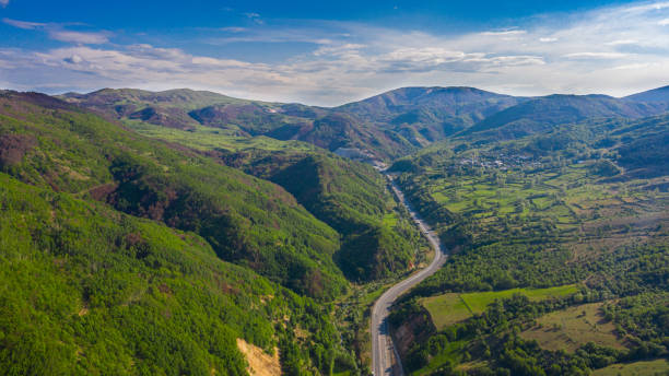istock Aerial View of a Road Through the Forest 2203156798