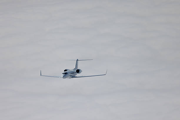 Private jet against the blue sky as it approaches Nice, France