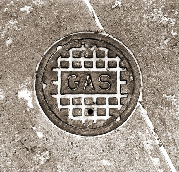 A gas shut off cover with a very light covering of snow that has fallen into the low parts of the cover. Fun fact: was shot with a Robot Royal 24 spring-powered camera.